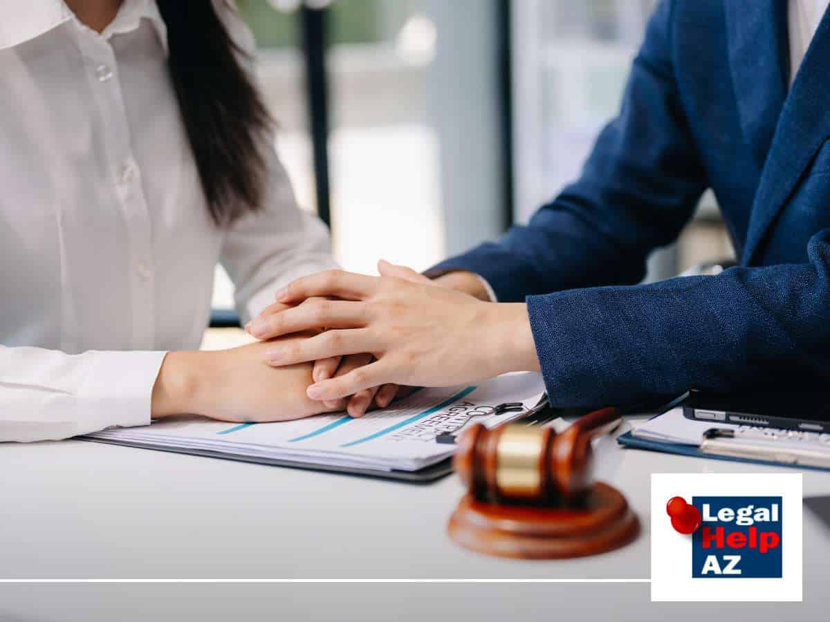 Divorce attorney offering support to a client during a consultation, with a gavel and legal documents on the table